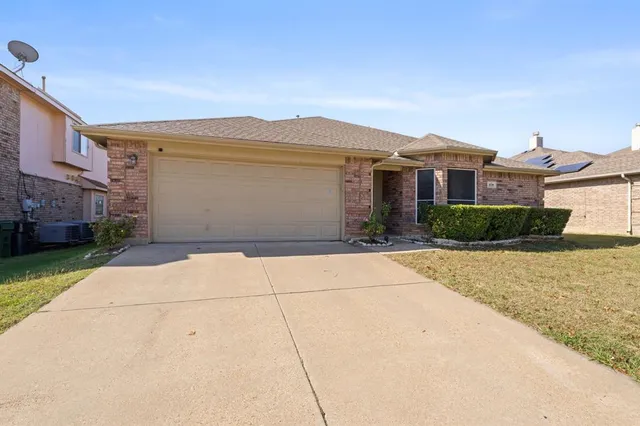 a view of house with a garden and pathway