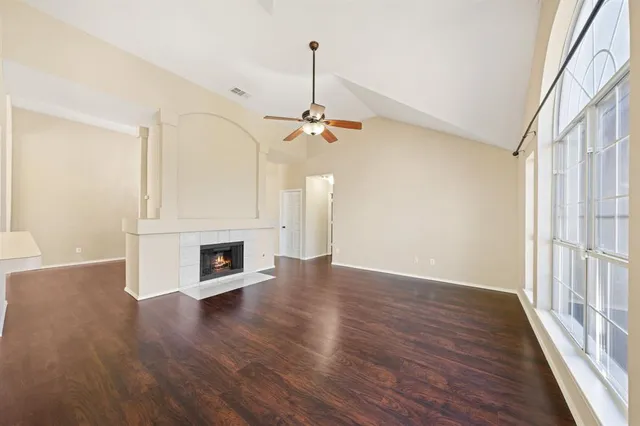 wooden floor in an empty room with a fireplace