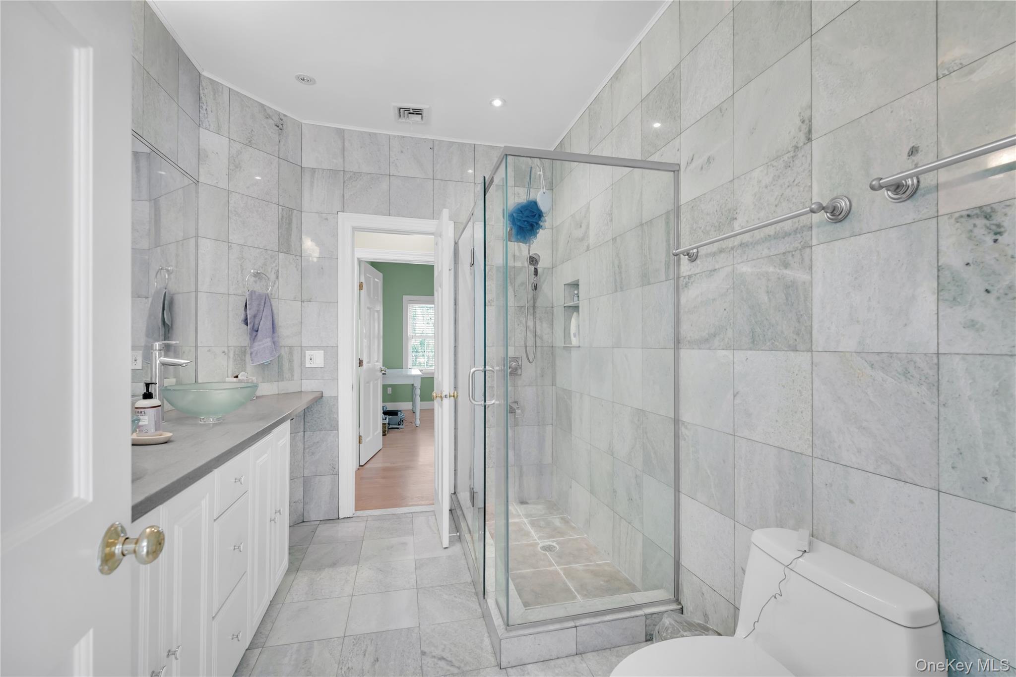 59 Orchard Hill Road Katonah, NY 10536 - Photo 17 of 27 a spacious bathroom with a shower sink and mirror