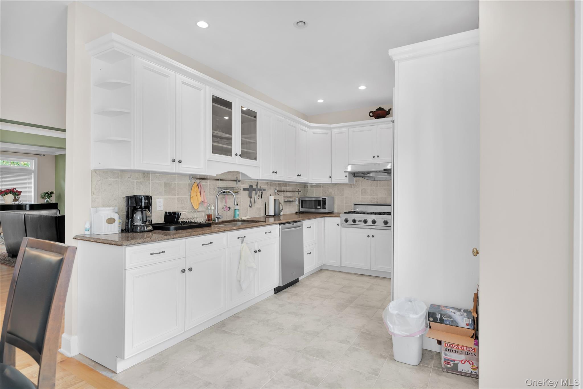 59 Orchard Hill Road Katonah, NY 10536 - Photo 8 of 27 a kitchen with granite countertop a sink stove and cabinets
