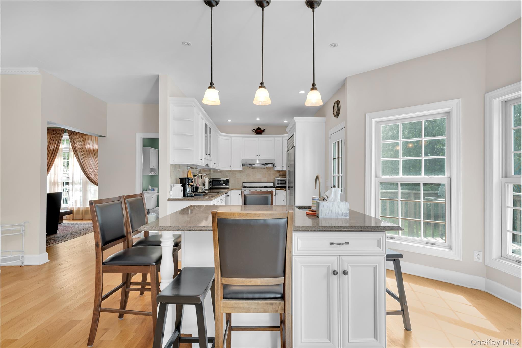 59 Orchard Hill Road Katonah, NY 10536 - Photo 9 of 27 a view of a dining room and livingroom with furniture wooden floor a chandelier