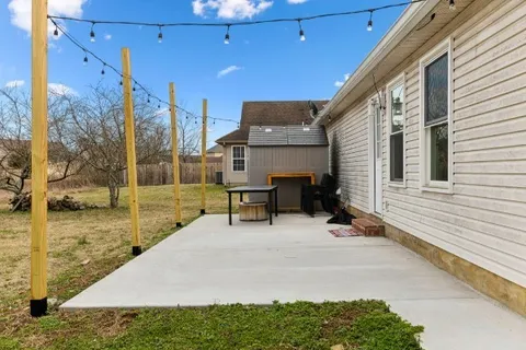 a view of a patio with a table and chairs