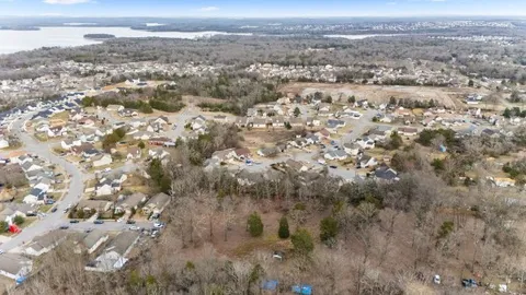 an aerial view of house with yard and mountain view in back