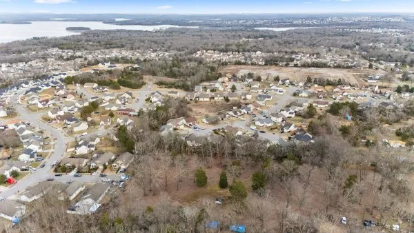 an aerial view of house with yard and mountain view in back