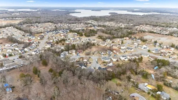 an aerial view of residential houses with outdoor space