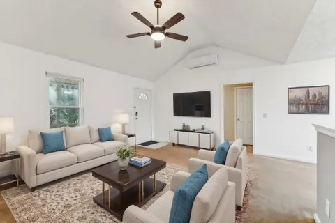 a living room with furniture and a flat screen tv