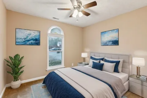 a bedroom with a bed and a painting on the wall