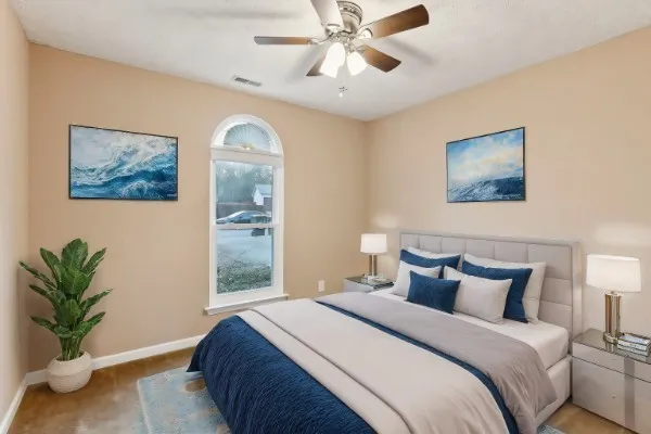 a bedroom with a bed and a painting on the wall