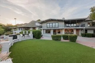 a front view of a house with a yard table and chairs