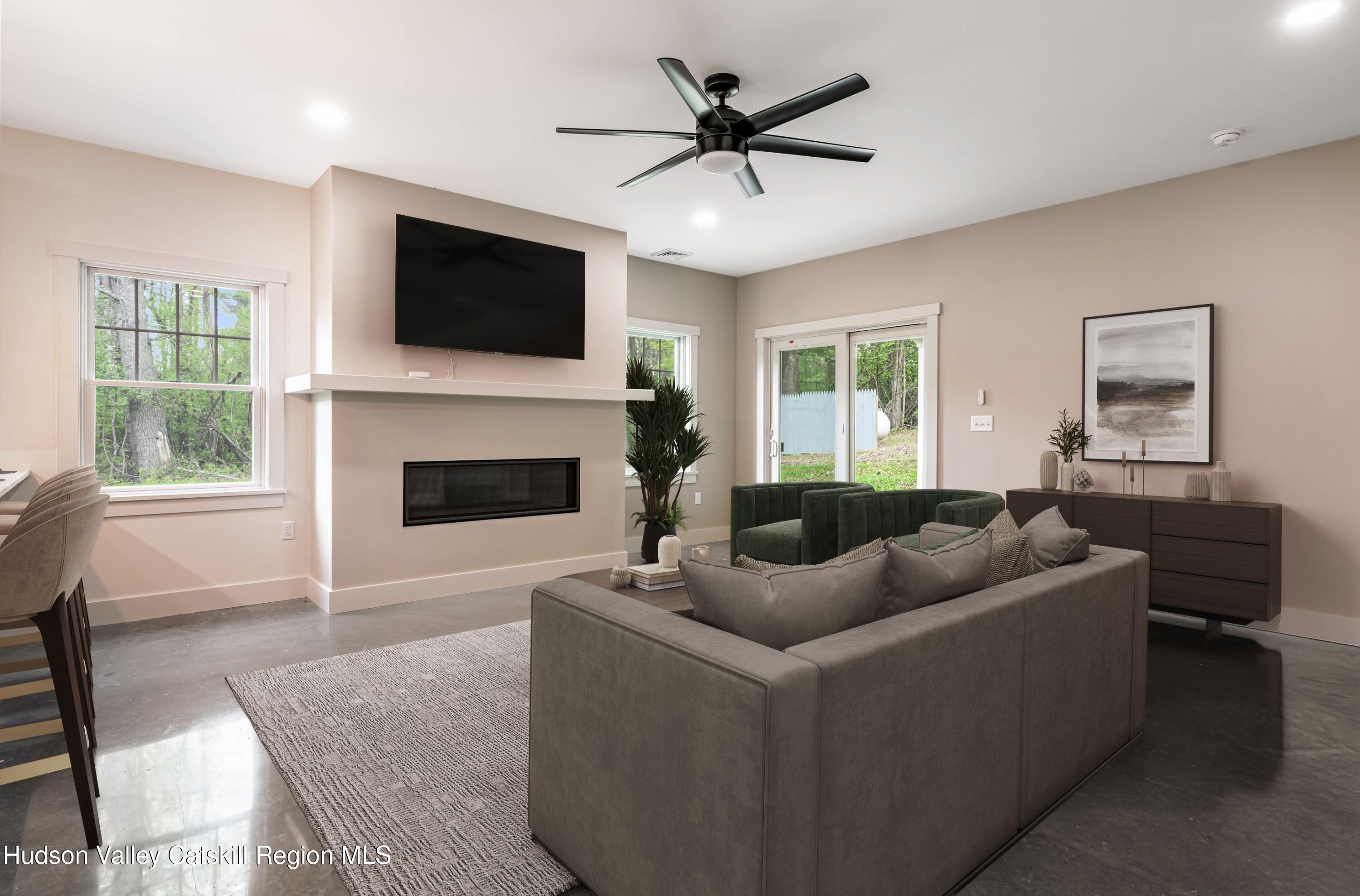 1980 Sleepy Hollow Road Athens, NY 12015 - Photo 12 of 40 a living room with furniture a flat screen tv and a fireplace