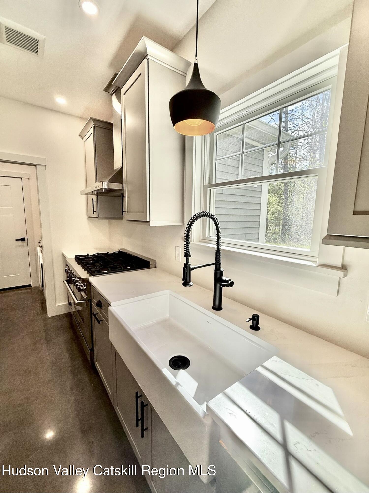 1980 Sleepy Hollow Road Athens, NY 12015 - Photo 9 of 40 a kitchen with a sink a stove and a chandelier
