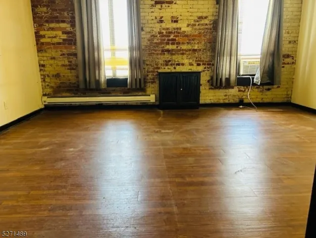 a view of a room with wooden floor