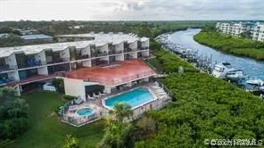 a view of a house with a garden and lake view