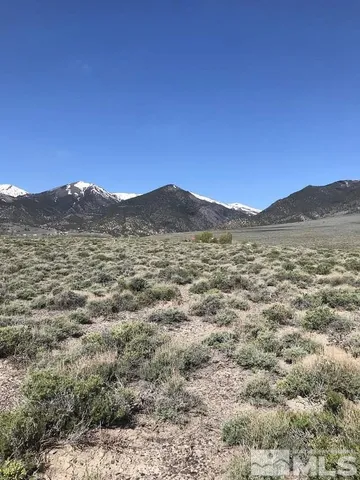 a view of a large mountain with mountains in the background