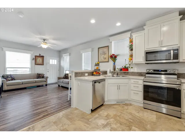 a kitchen with microwave a stove and cabinets
