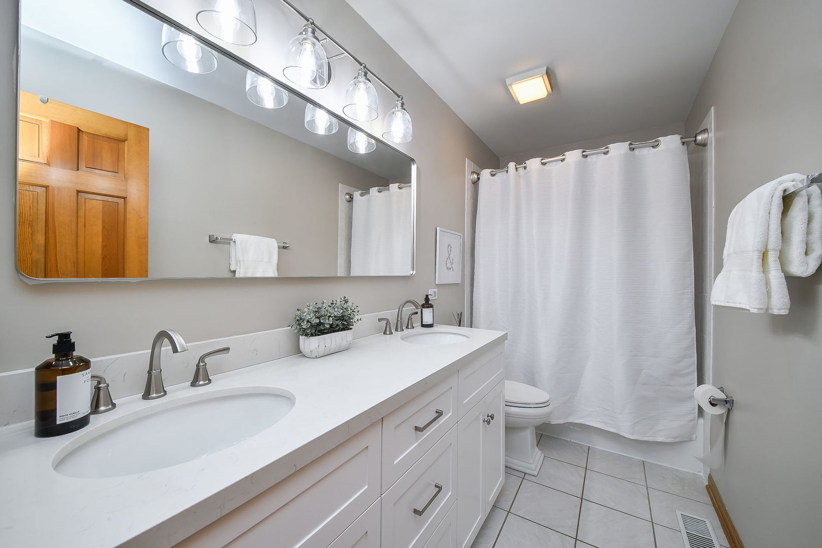 1206 Beckman Lane Batavia, IL 60510 - Photo 25 of 42 a bathroom with a double vanity sink toilet and a mirror