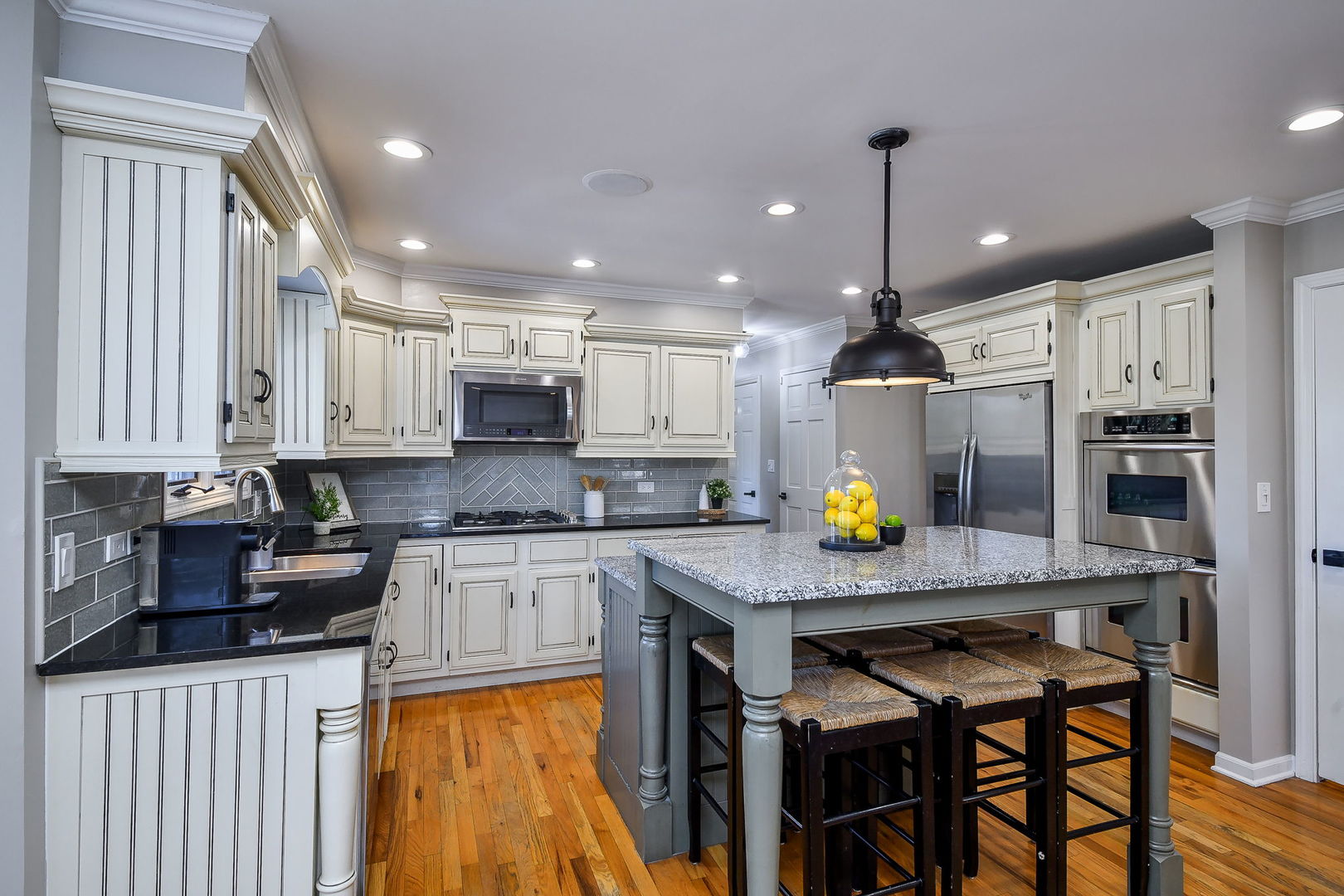 1206 Beckman Lane Batavia, IL 60510 - Photo 3 of 42 a kitchen with stainless steel appliances granite countertop table chairs sink refrigerator and cabinets