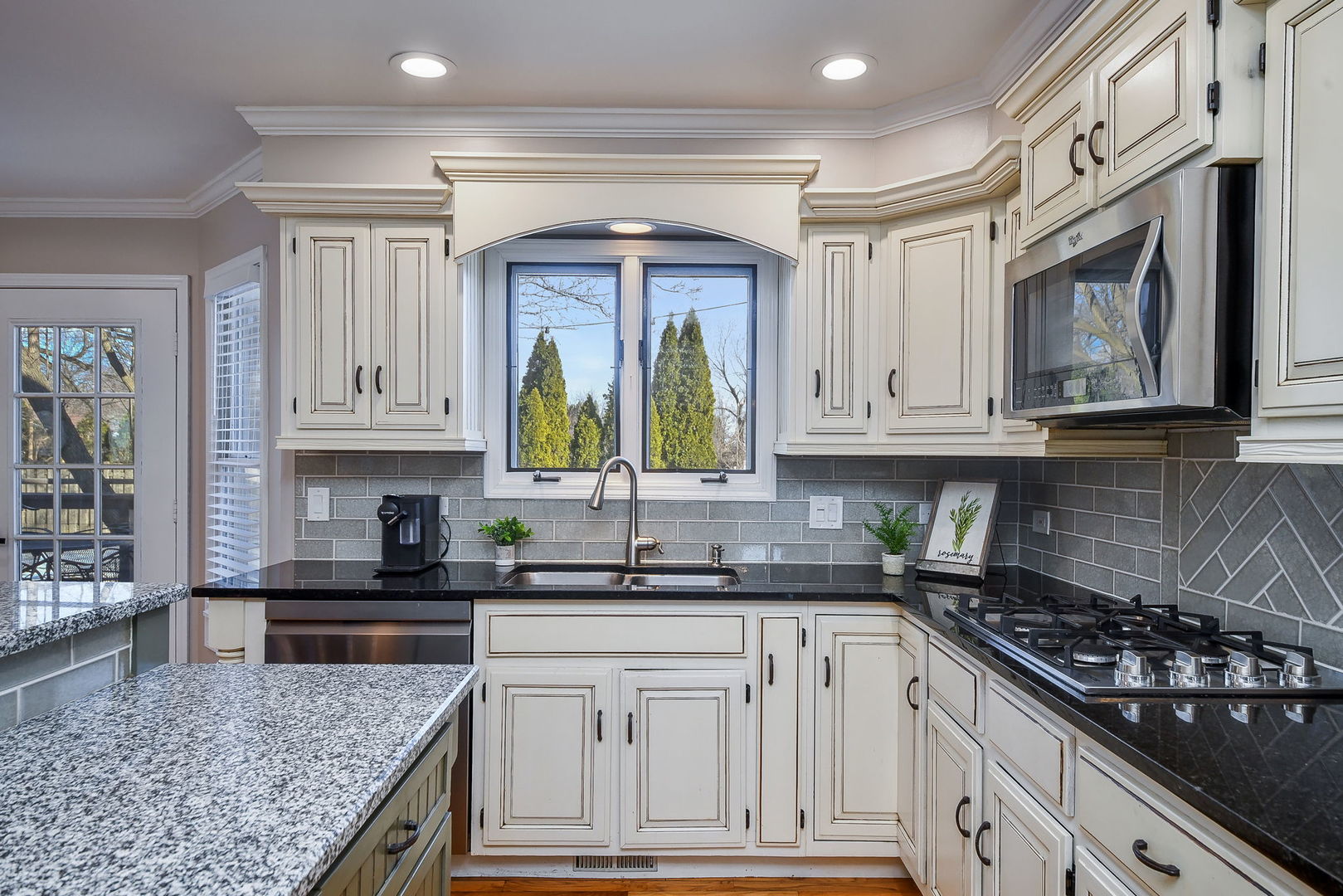 1206 Beckman Lane Batavia, IL 60510 - Photo 4 of 42 a kitchen with granite countertop a sink stove and cabinets