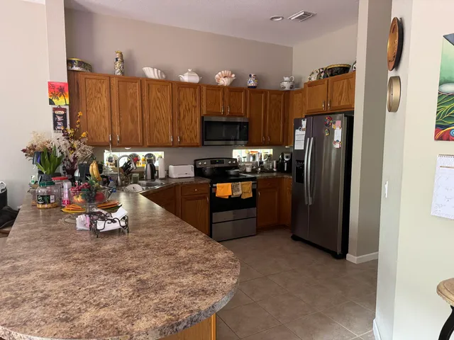 a kitchen with a refrigerator and a sink