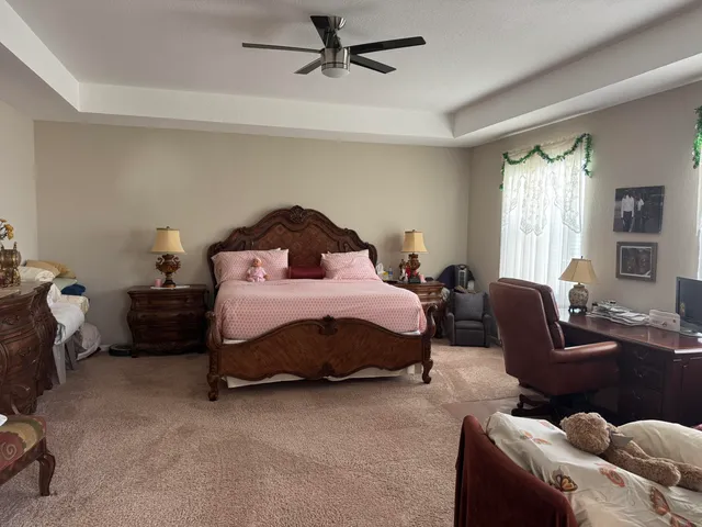 a bedroom with a bed couch and a window