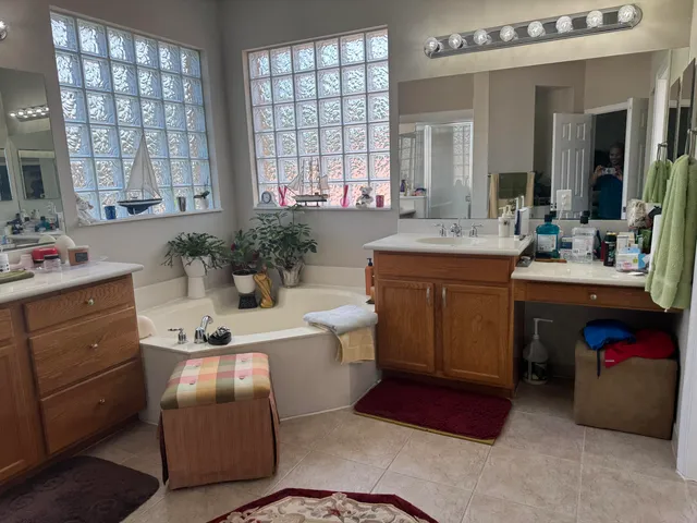 a room with a washer dryer and potted plants