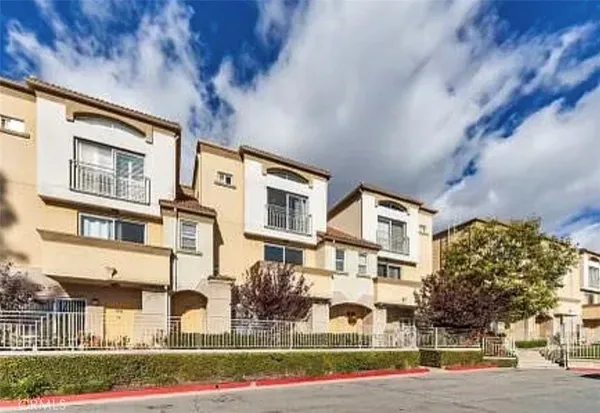 a front view of a residential apartment building with a yard