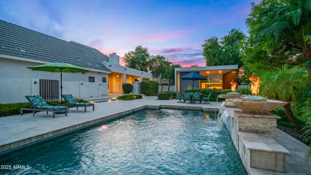 a spacious bathroom with a granite countertop sink a mirror and a bathtub