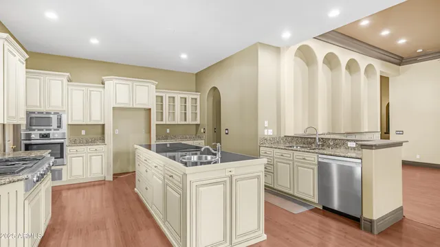 a kitchen with stainless steel appliances granite countertop a stove oven and a refrigerator