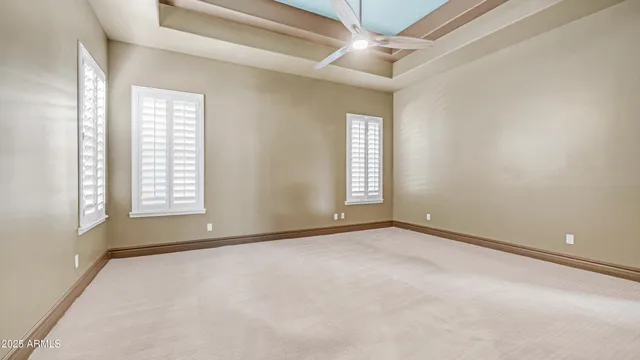 a view of a white house with a large tree