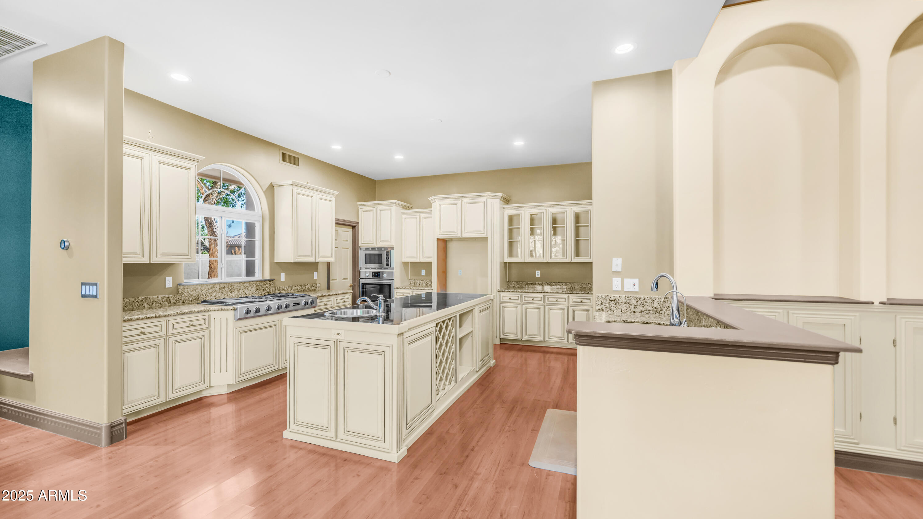 7467 South Rita Lane Tempe, AZ 85283 - Photo 63 of 111 a large kitchen with stainless steel appliances granite countertop a lot of counter space and wooden floors