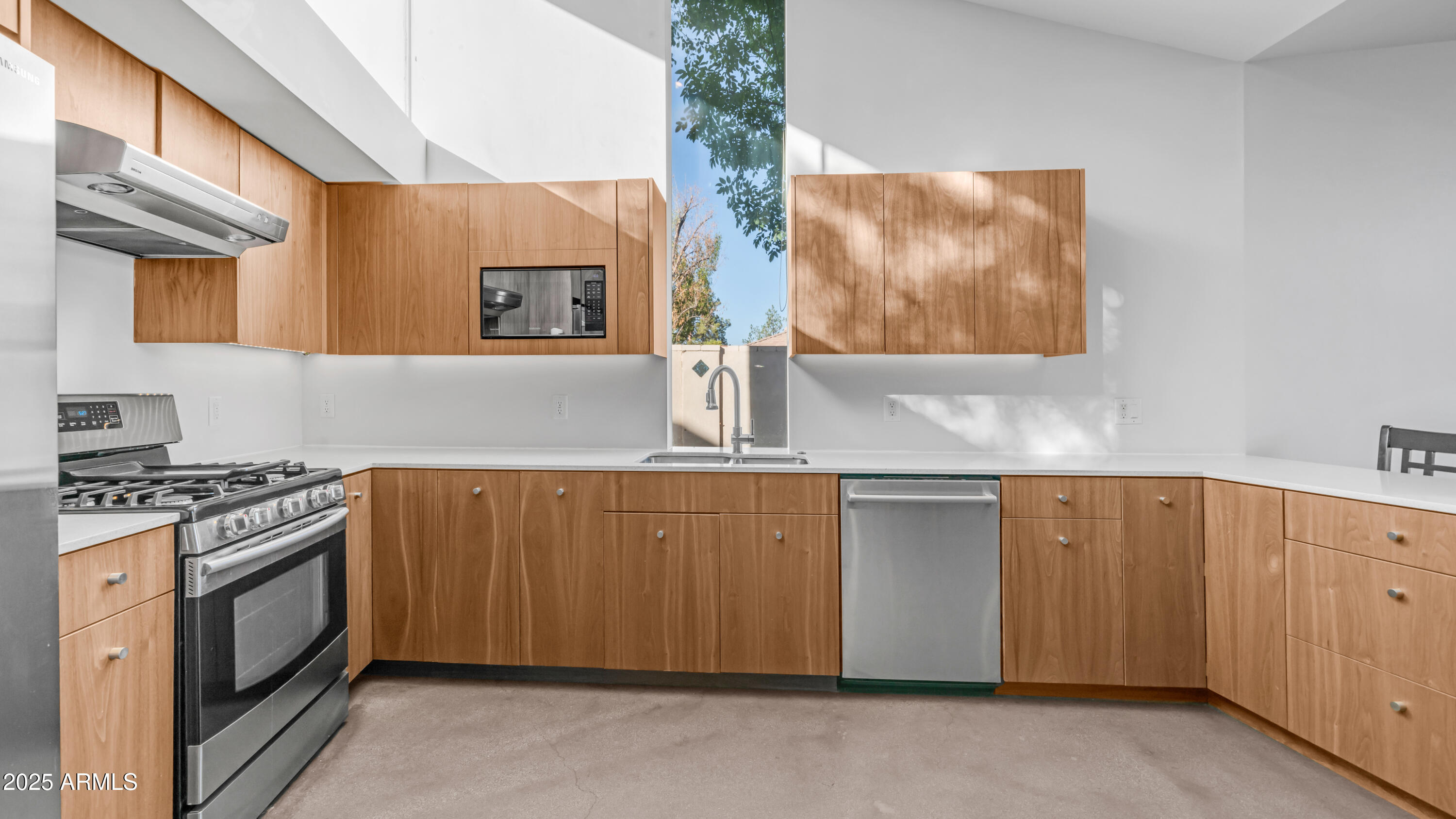 7467 South Rita Lane Tempe, AZ 85283 - Photo 78 of 111 a kitchen with stainless steel appliances granite countertop a stove a sink and a microwave