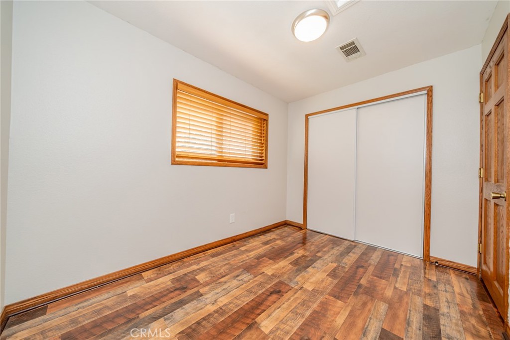 1724 Thrush Road Wrightwood, CA 92397 - Photo 11 of 39 a view of an empty room with wooden floor and a window