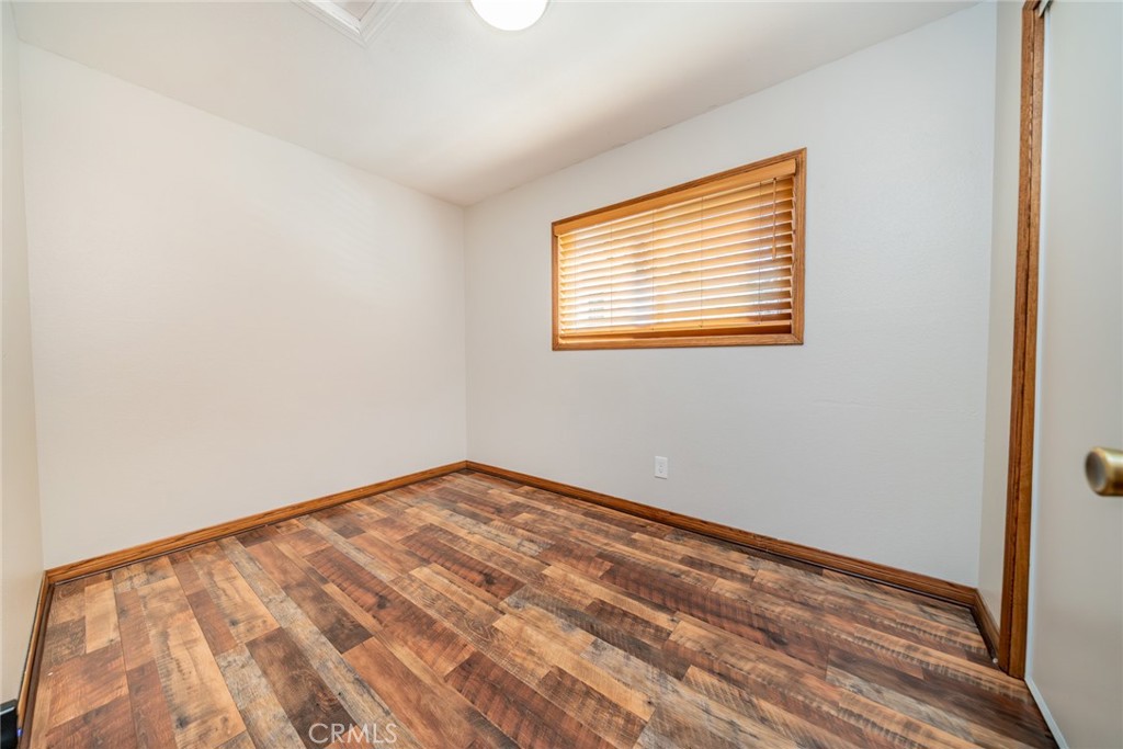1724 Thrush Road Wrightwood, CA 92397 - Photo 12 of 39 a view of an empty room with wooden floor and a window