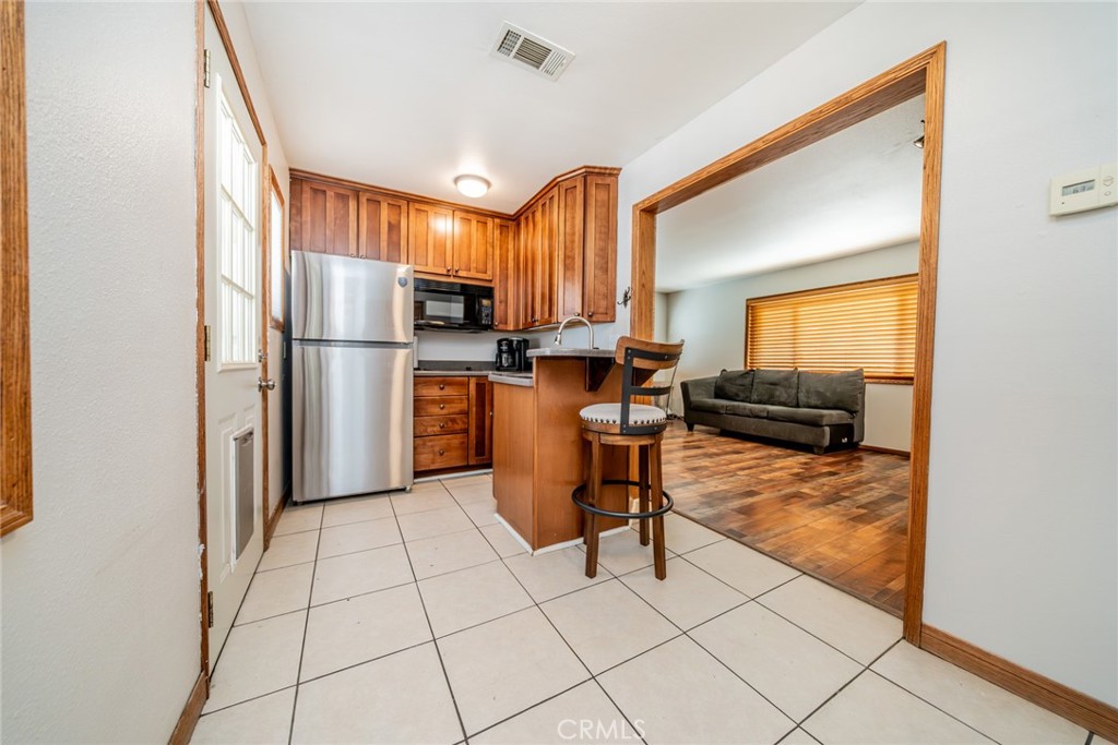 1724 Thrush Road Wrightwood, CA 92397 - Photo 16 of 39 a kitchen with stainless steel appliances granite countertop a refrigerator and a stove top oven