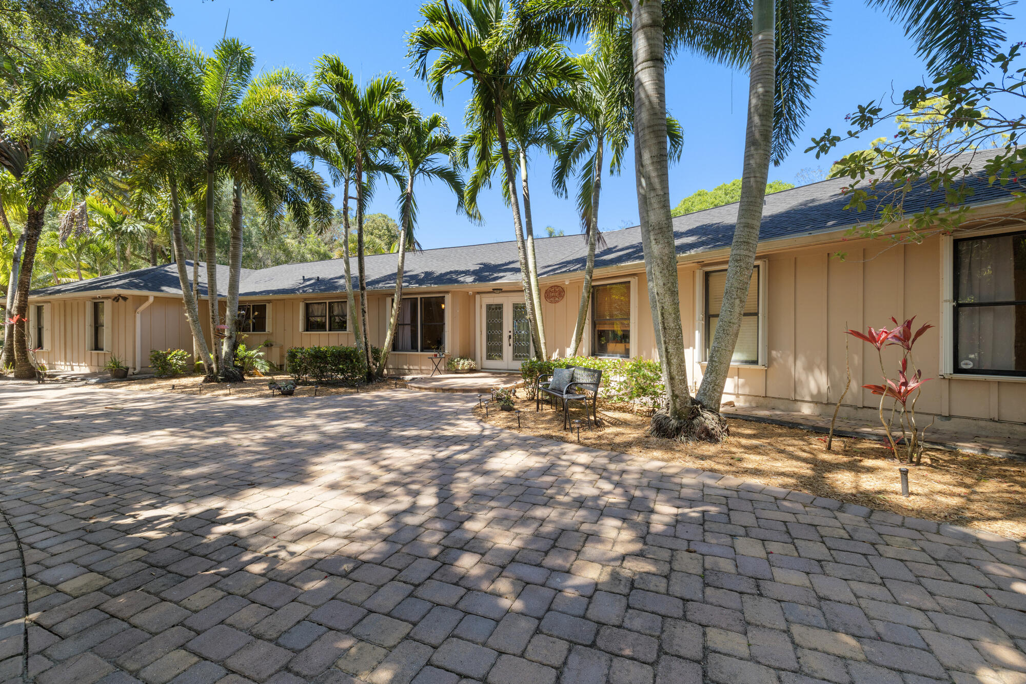 8515 Thousand Pines Circle West Palm Beach, FL 33411 - Photo 1 of 31 a view of a house with a yard and large trees