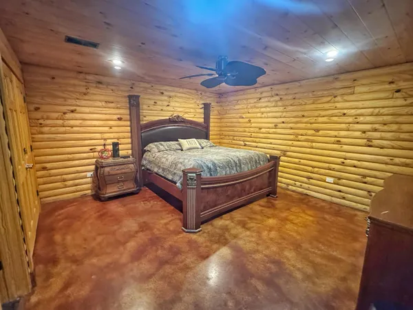 a bedroom with a bed and a view of wall