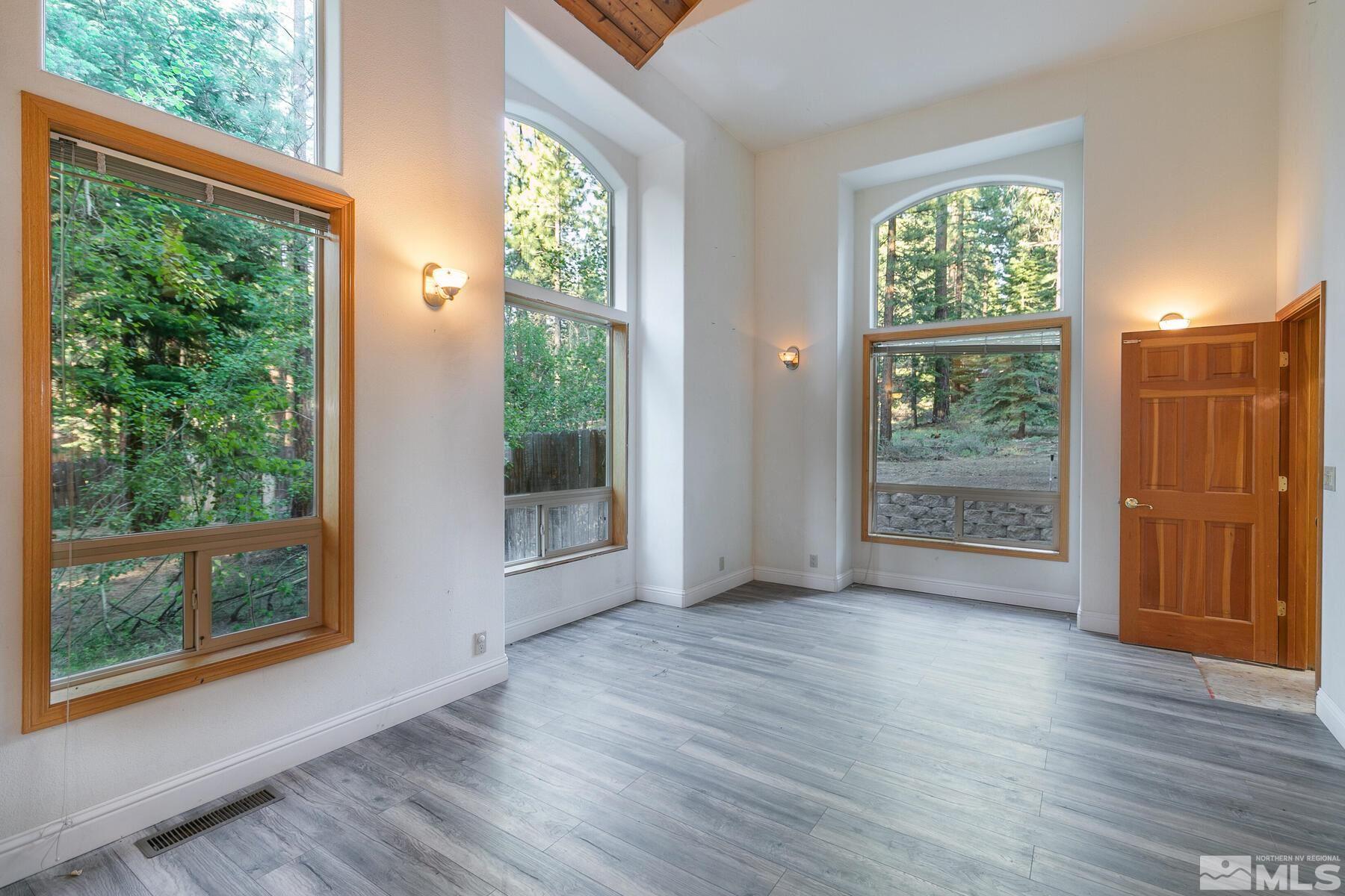 119 Meadow Drive Stateline, NV 89449 - Photo 12 of 30 an empty room with wooden floor and windows