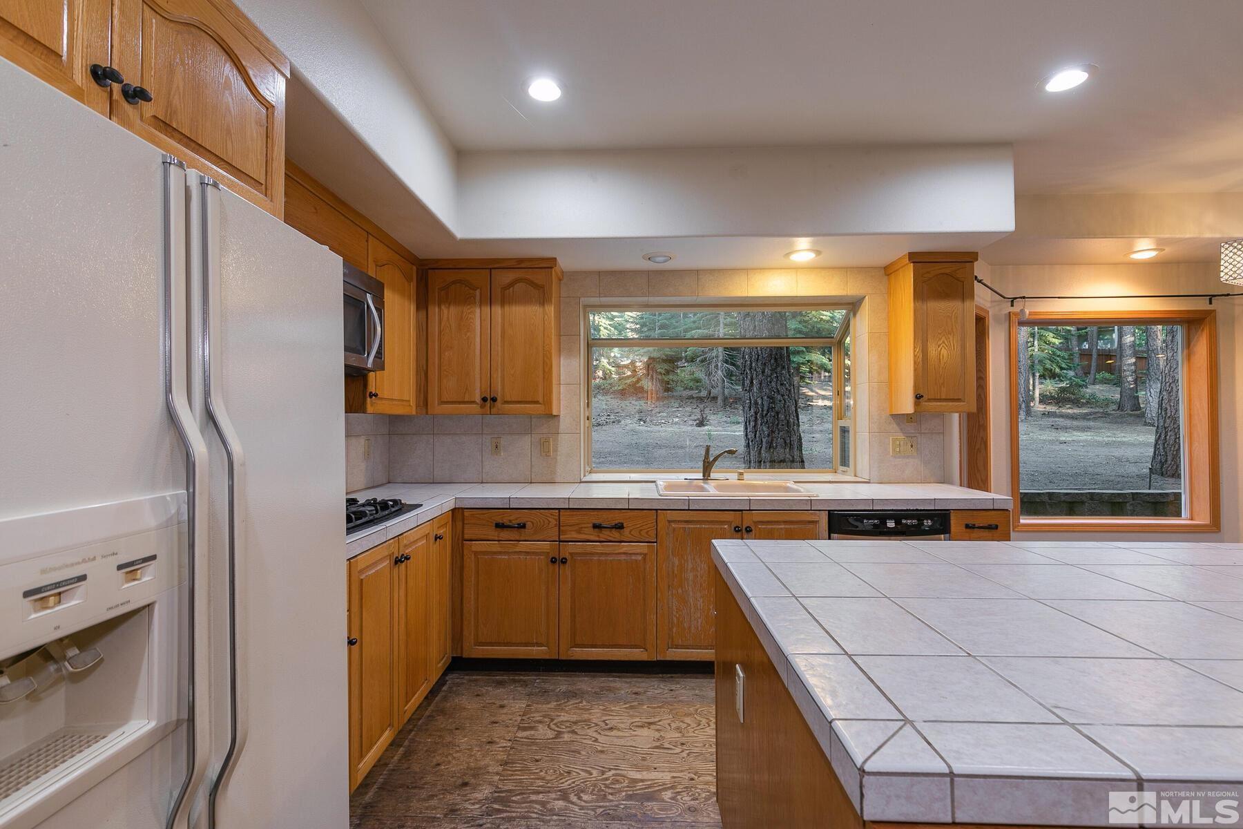 119 Meadow Drive Stateline, NV 89449 - Photo 13 of 30 a kitchen with a sink stainless steel appliances a counter top space and cabinets