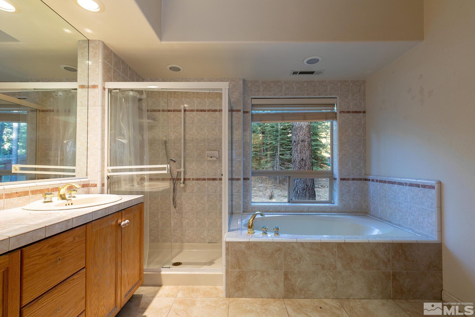 119 Meadow Drive Stateline, NV 89449 - Photo 19 of 30 a bathroom with a tub sink and mirror