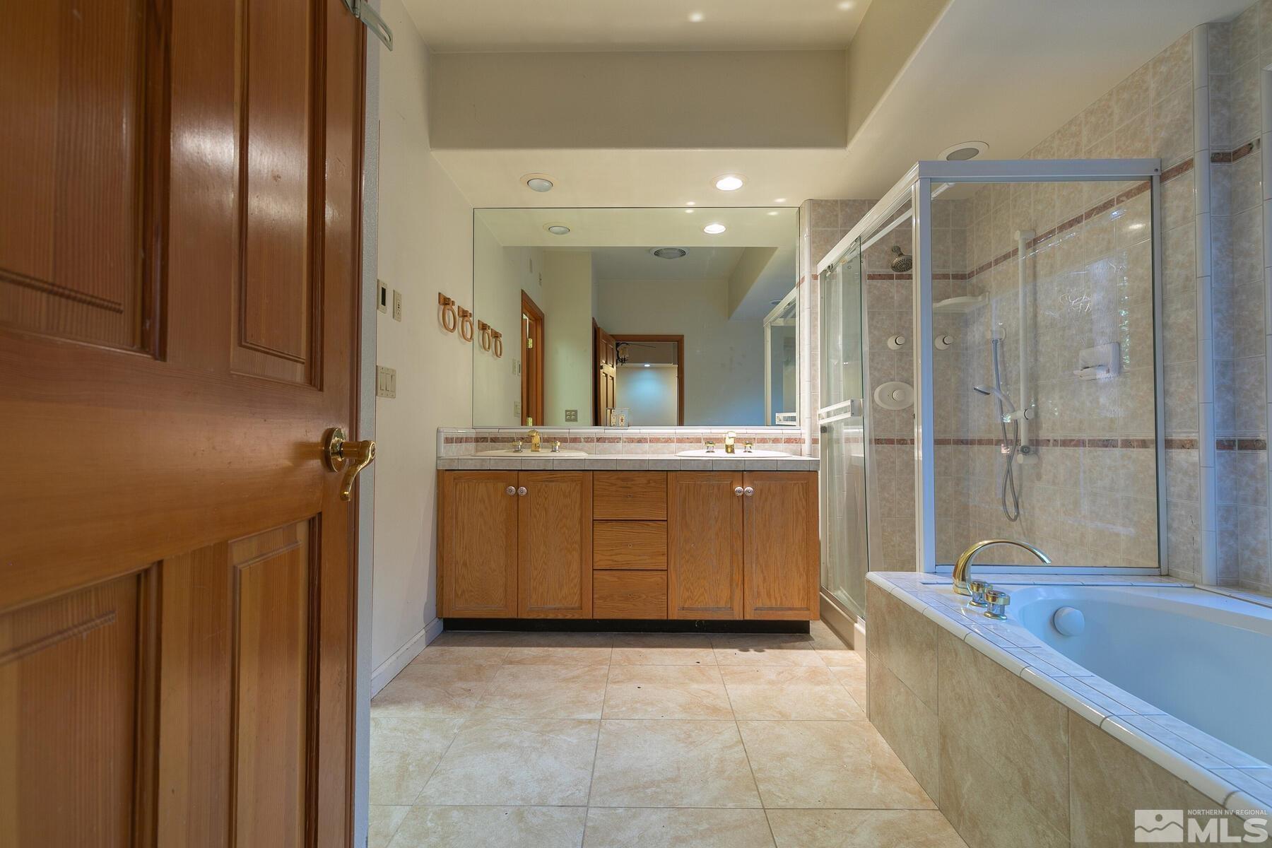 119 Meadow Drive Stateline, NV 89449 - Photo 20 of 30 a bathroom with a tub sink and mirror