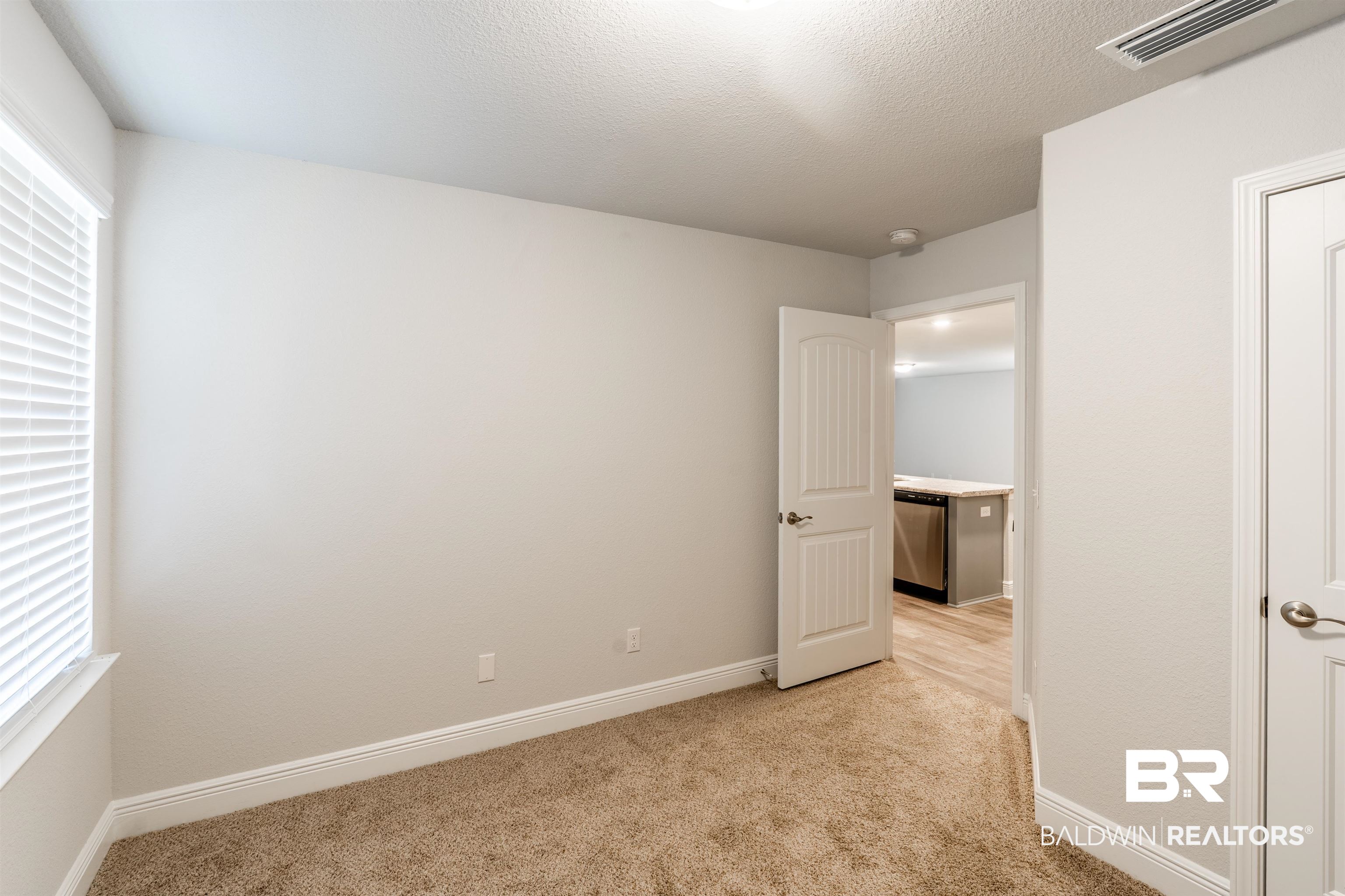 1906 Stonepine Drive South Semmes, AL 36575 - Photo 12 of 30 Unfurnished bedroom with light colored carpet and a textured ceiling