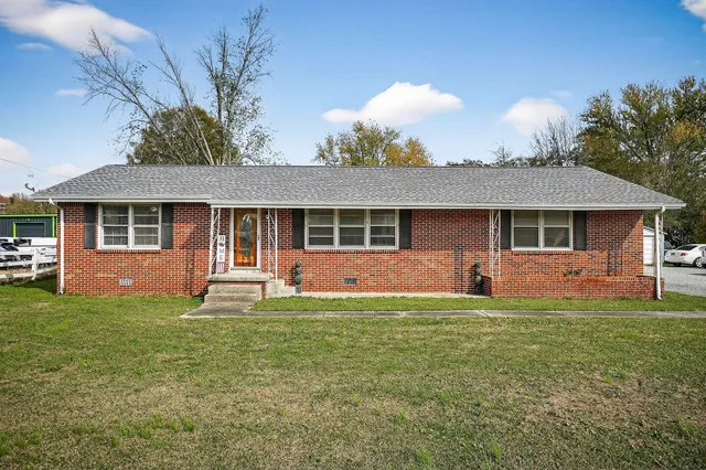 a front view of a house with a yard and porch