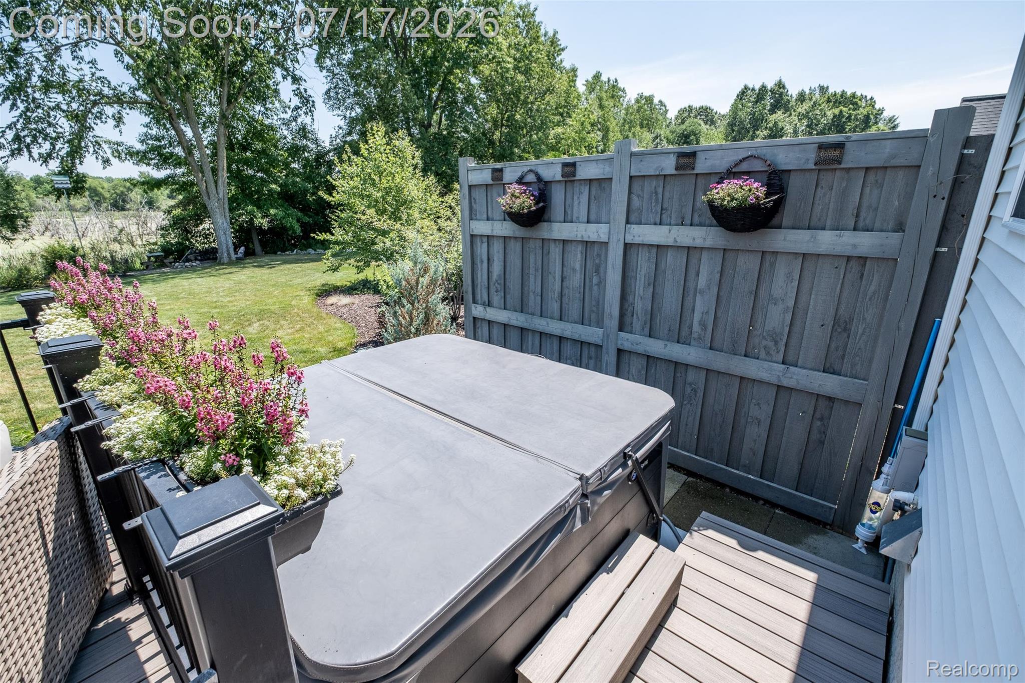 12349 Sugar Maple Drive Fenton, MI 48430 - Photo 54 of 67 Backyard area featuring a hot tub with cover, wood-finish decking, and a privacy fence