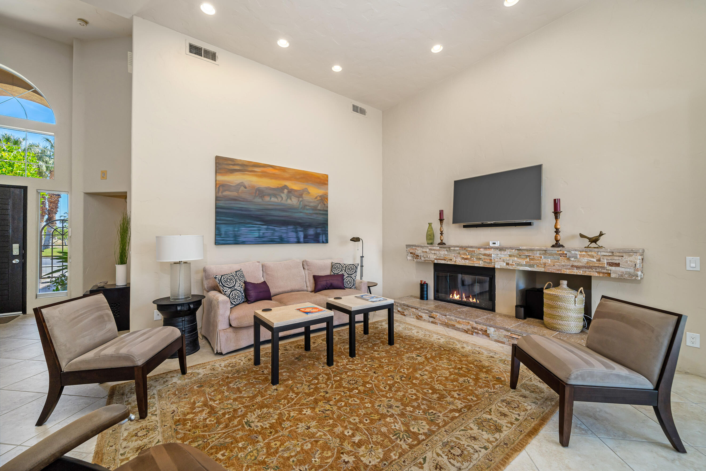 56565 Riviera La Quinta, CA 92253 - Photo 14 of 48 a living room with furniture a fireplace and a flat screen tv