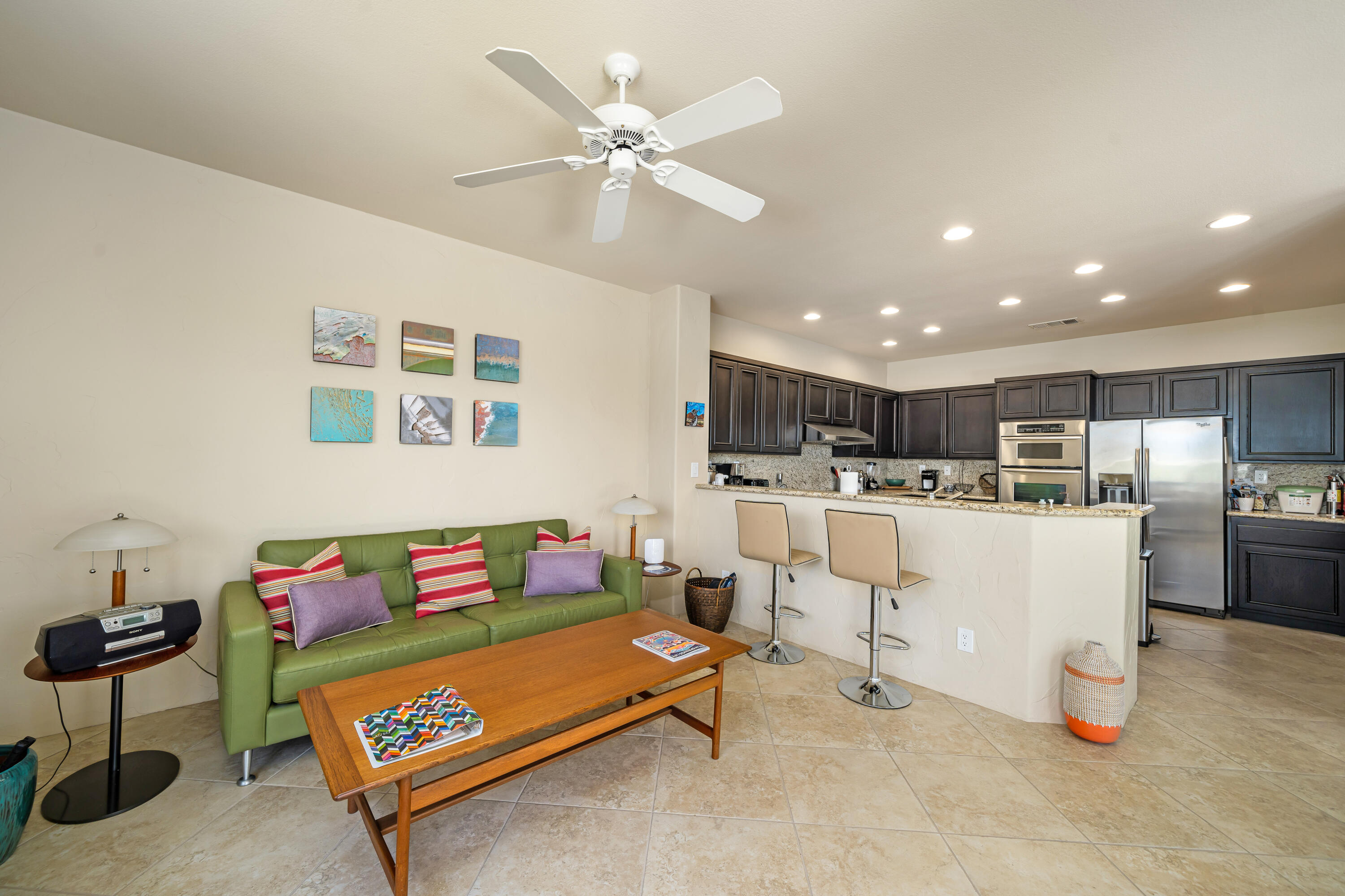 56565 Riviera La Quinta, CA 92253 - Photo 23 of 48 a living room with furniture kitchen view and a chandelier