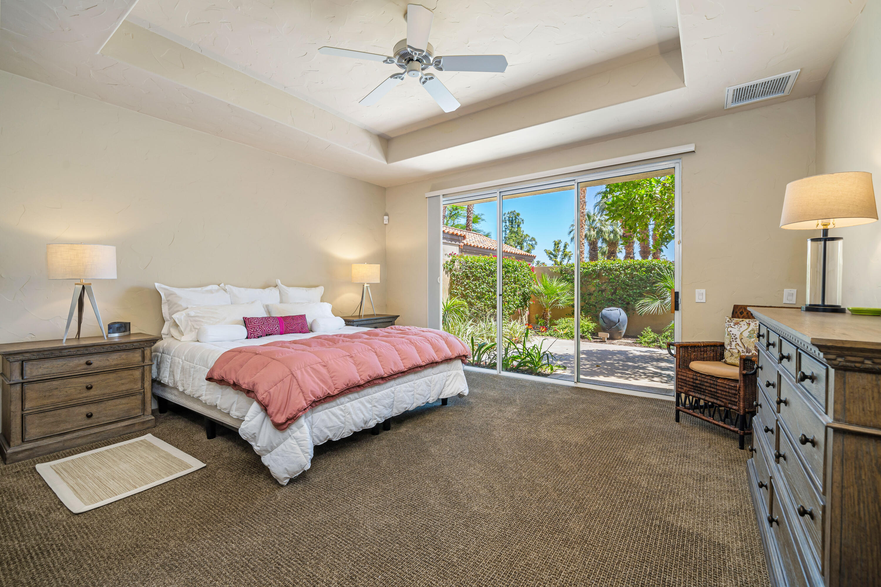 56565 Riviera La Quinta, CA 92253 - Photo 30 of 48 a spacious bedroom with a bed and a chandelier