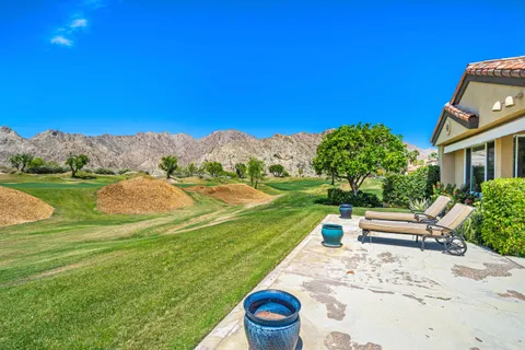 a view of a garden with a house in the background
