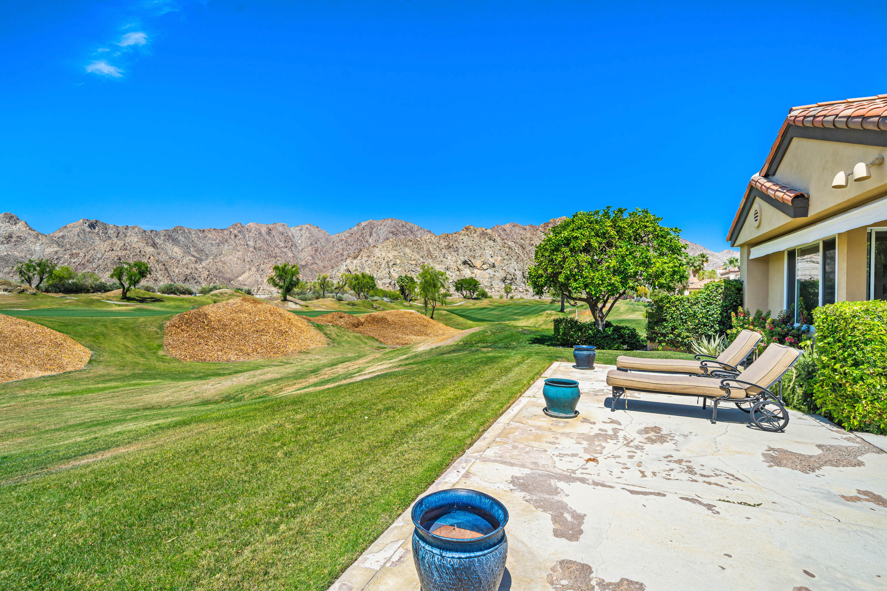 56565 Riviera La Quinta, CA 92253 - Photo 3 of 48 a view of a garden with a house in the background