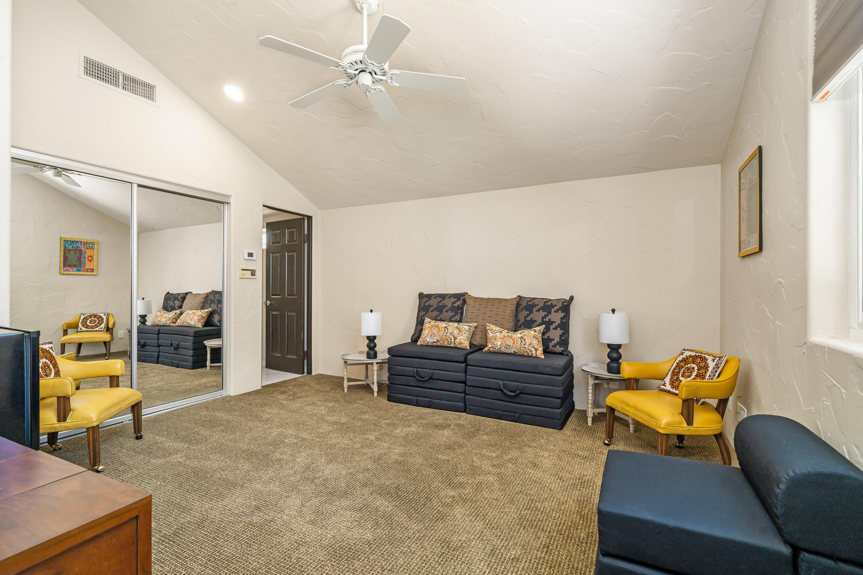 56565 Riviera La Quinta, CA 92253 - Photo 38 of 48 a living room with furniture and a chandelier