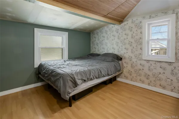 a bedroom with a bed and window